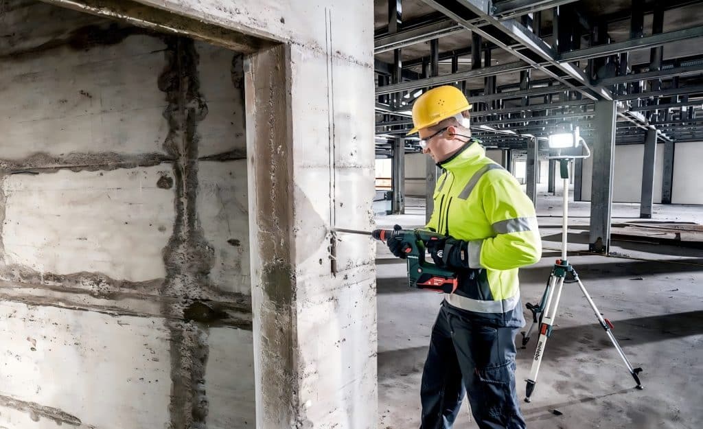 Construction worker using power portable station tools on a jobsite.